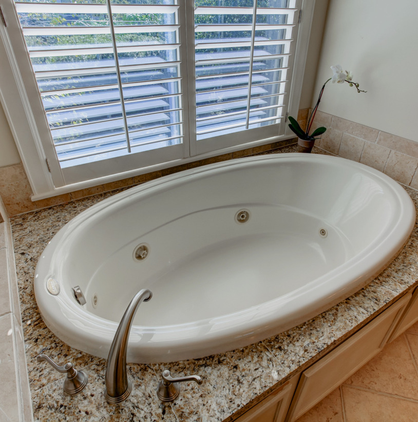 bathroom featuring natural light and a tub