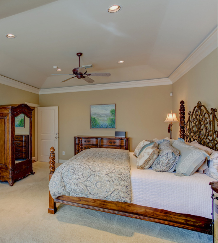 bedroom with a ceiling fan and carpet