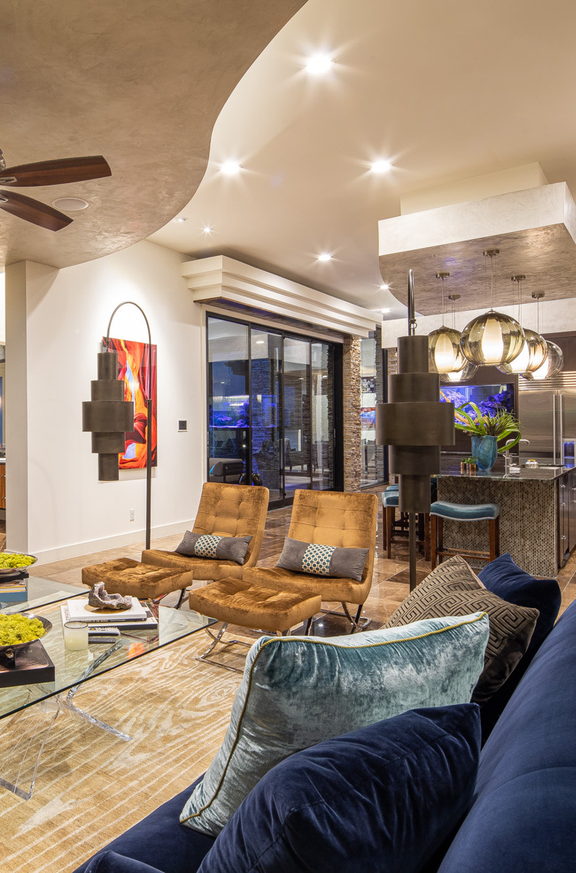 community lobby featuring hardwood flooring, a ceiling fan, and a fireplace