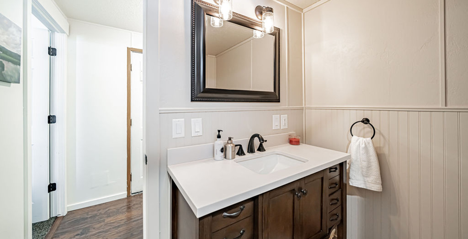 bathroom with vanity and multiple mirrors