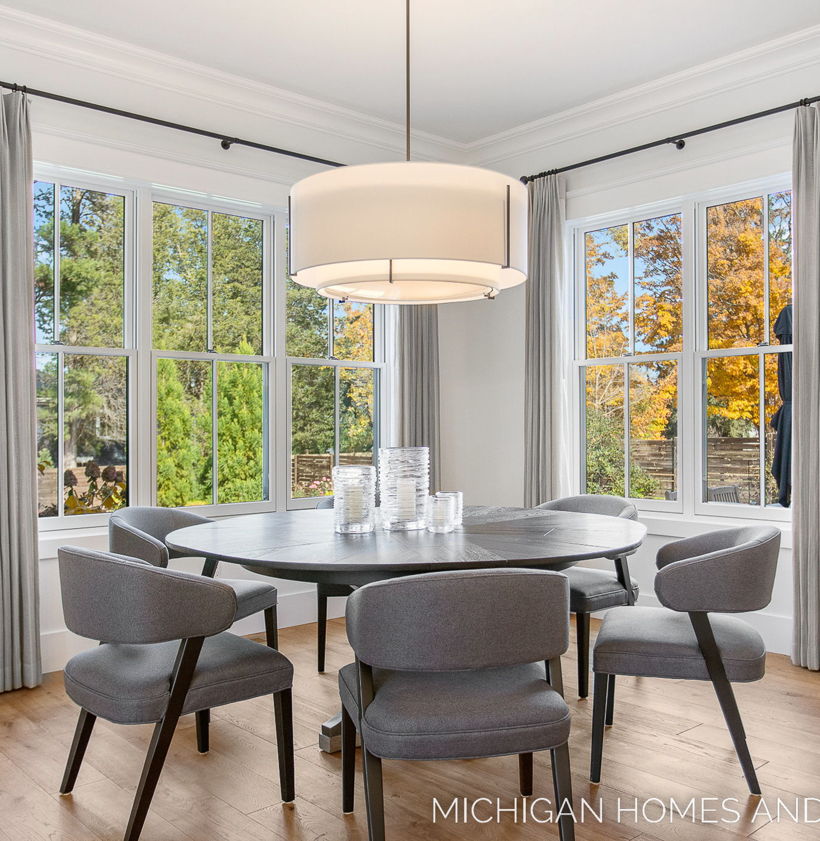 wood floored dining room featuring natural light