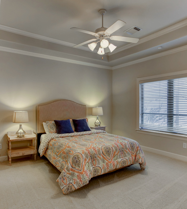 bedroom featuring a ceiling fan, carpet, and natural light