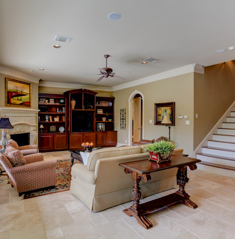 living room with a fireplace, natural light, and TV
