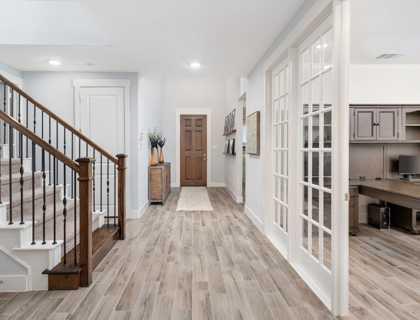 hardwood floored entrance foyer with french doors