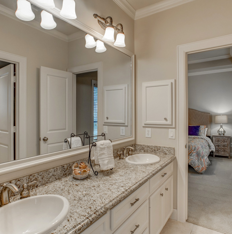 bathroom featuring dual bowl vanity and mirror