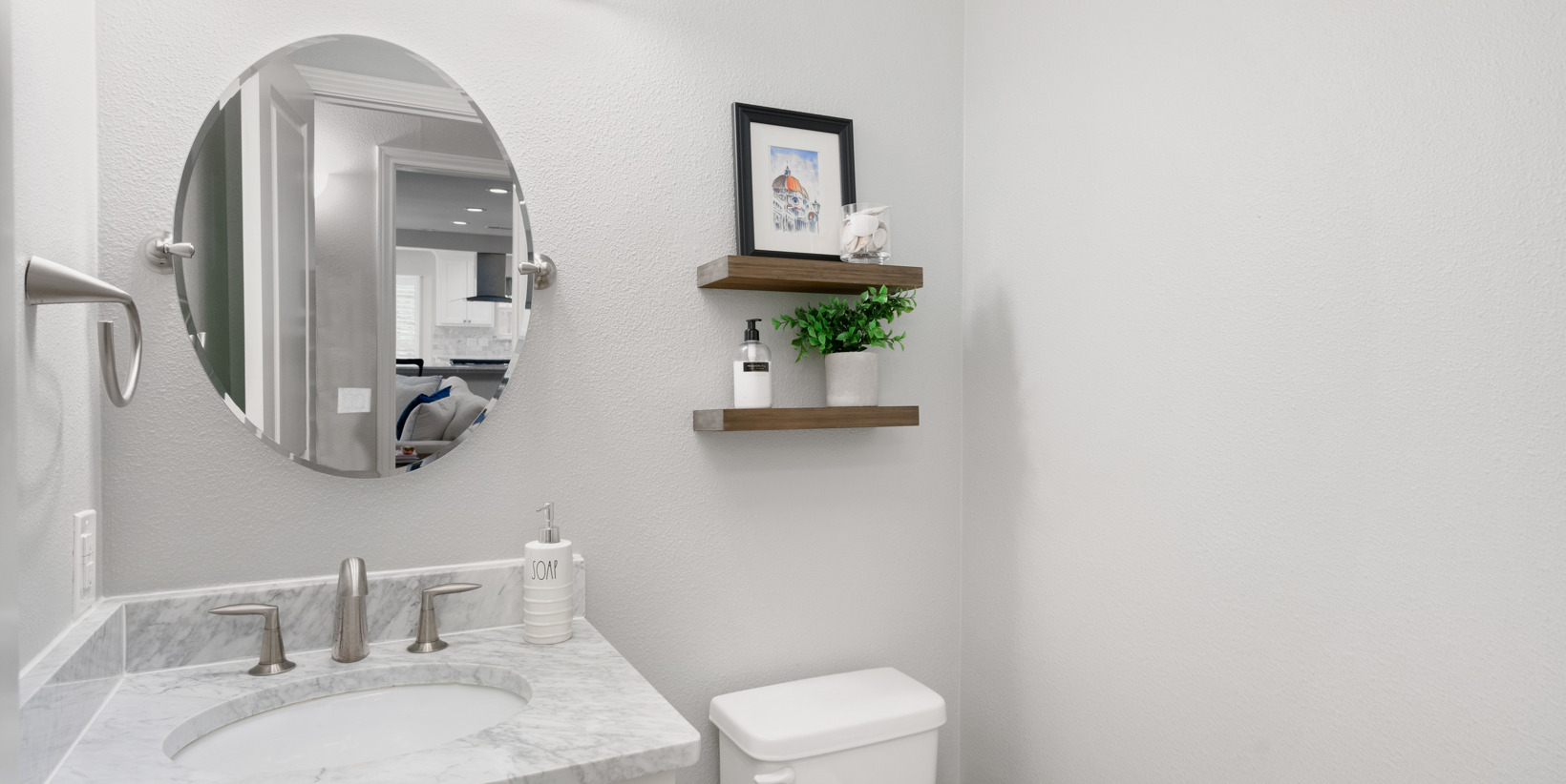 half bath with toilet, mirror, and vanity