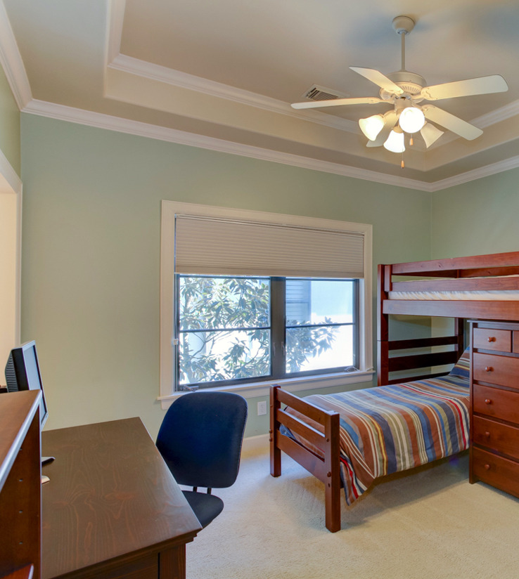 bedroom with a ceiling fan, natural light, and carpet