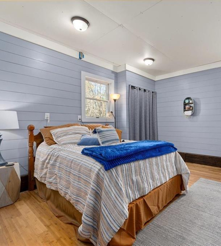 hardwood floored bedroom with natural light