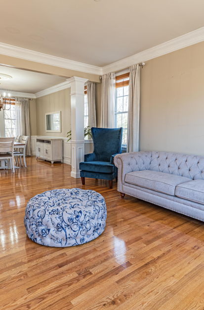 living room with natural light, hardwood flooring, and a chandelier
