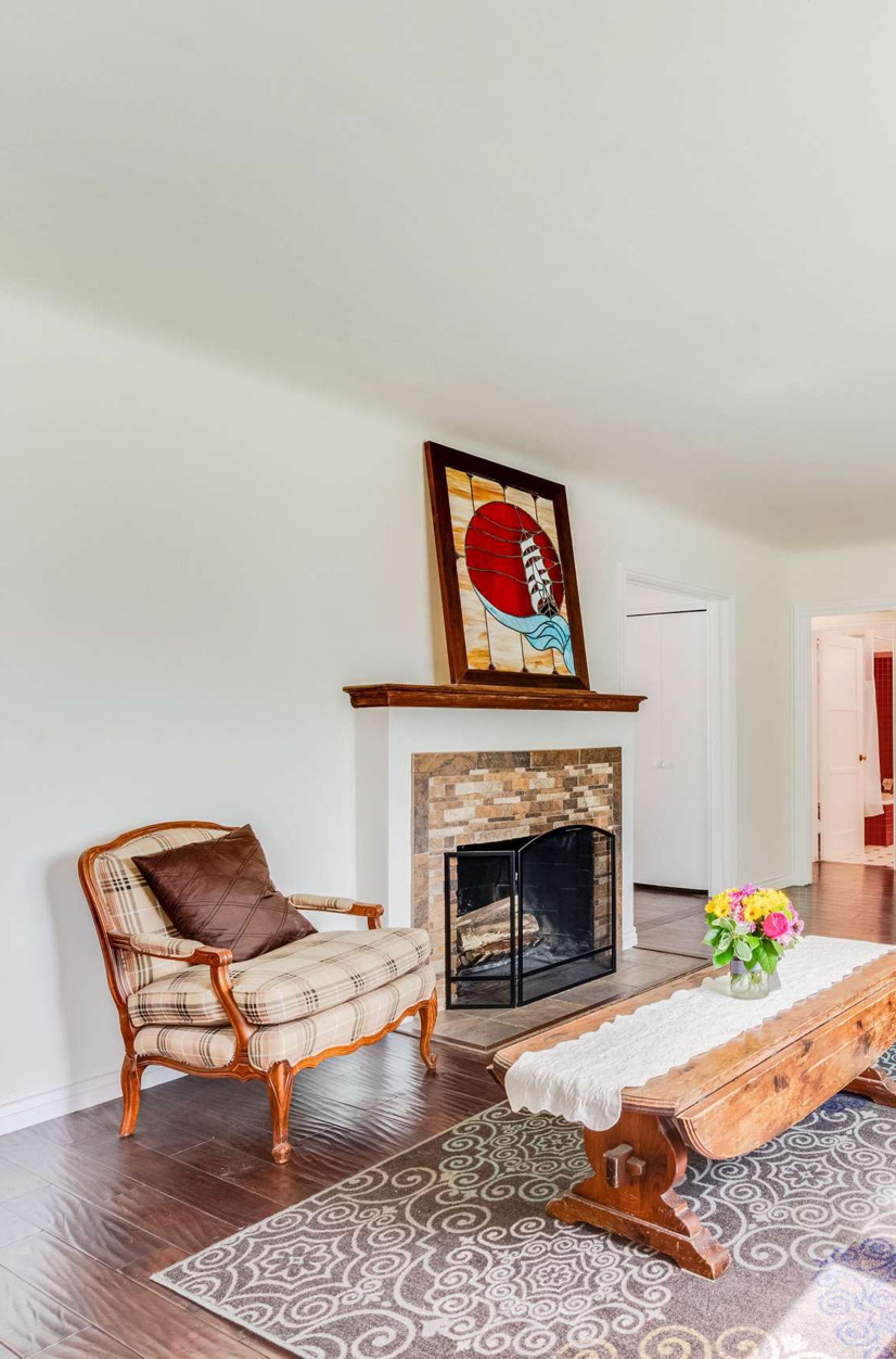 living room with hardwood floors and a fireplace