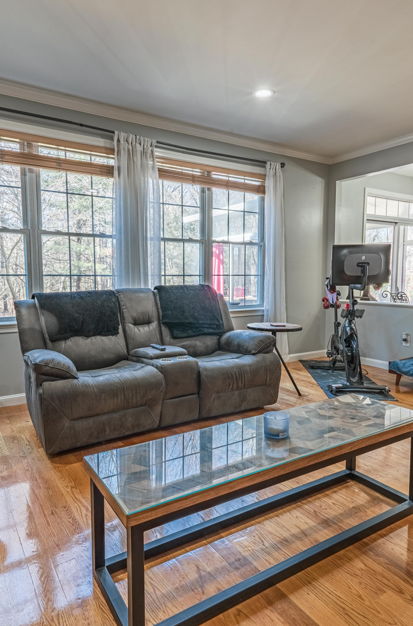 living room featuring natural light, hardwood floors, and microwave