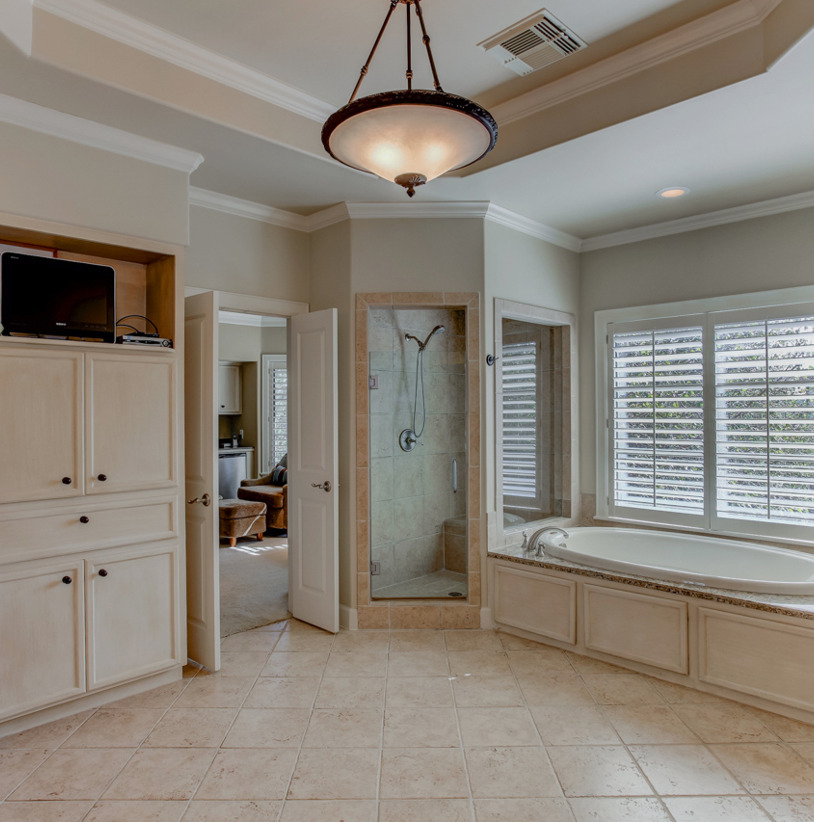 bathroom featuring tile floors, natural light, and separate shower and tub
